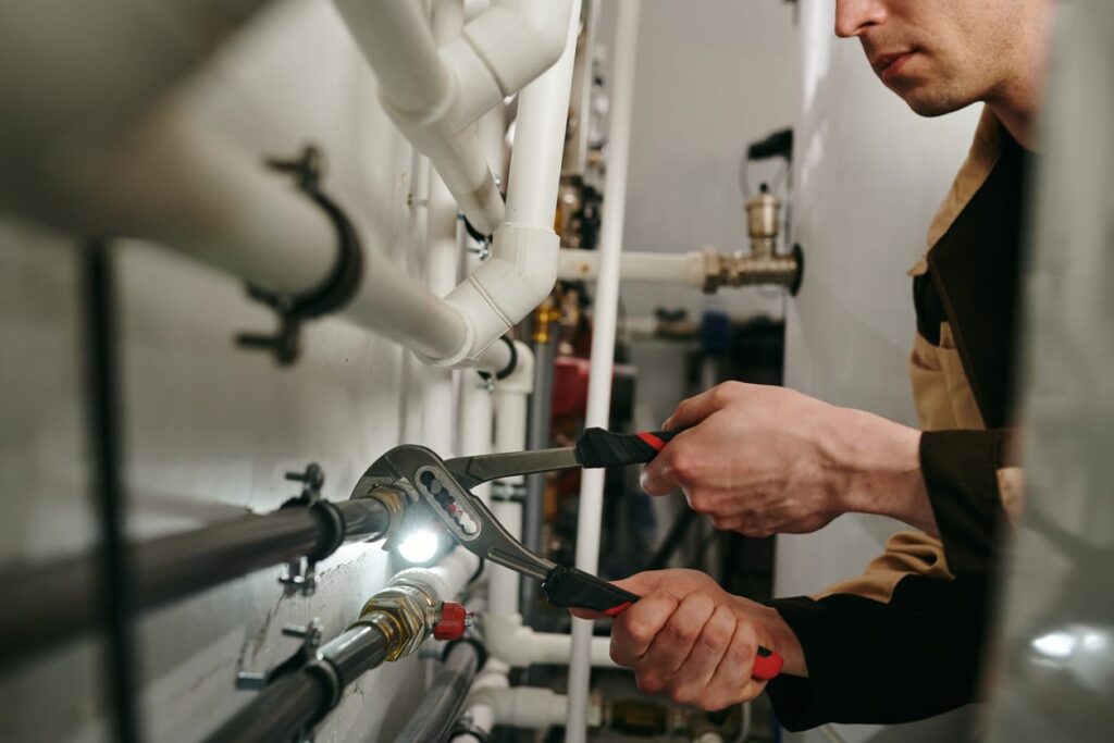 Plumbers maintaining commercial plumbing pipes in Fort Walton Beach