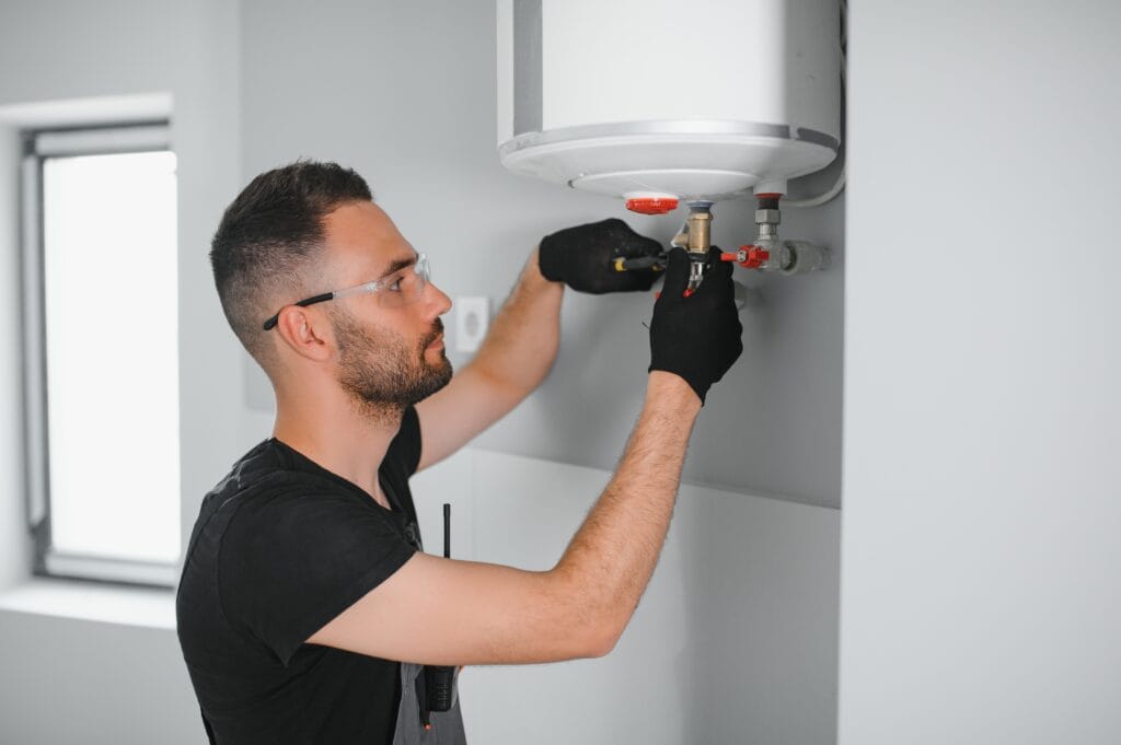 Technician performing water heater maintenance in Fort Walton Beach