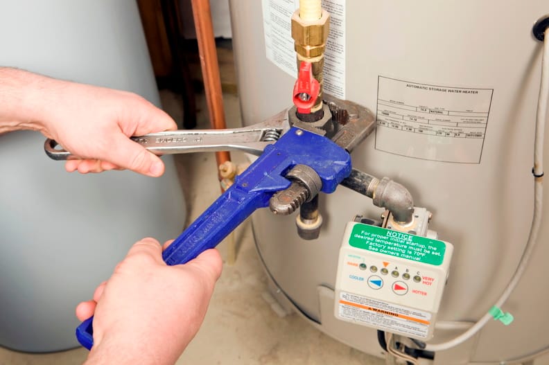 Plumber repairing a water heater valve in Fort Walton Beach